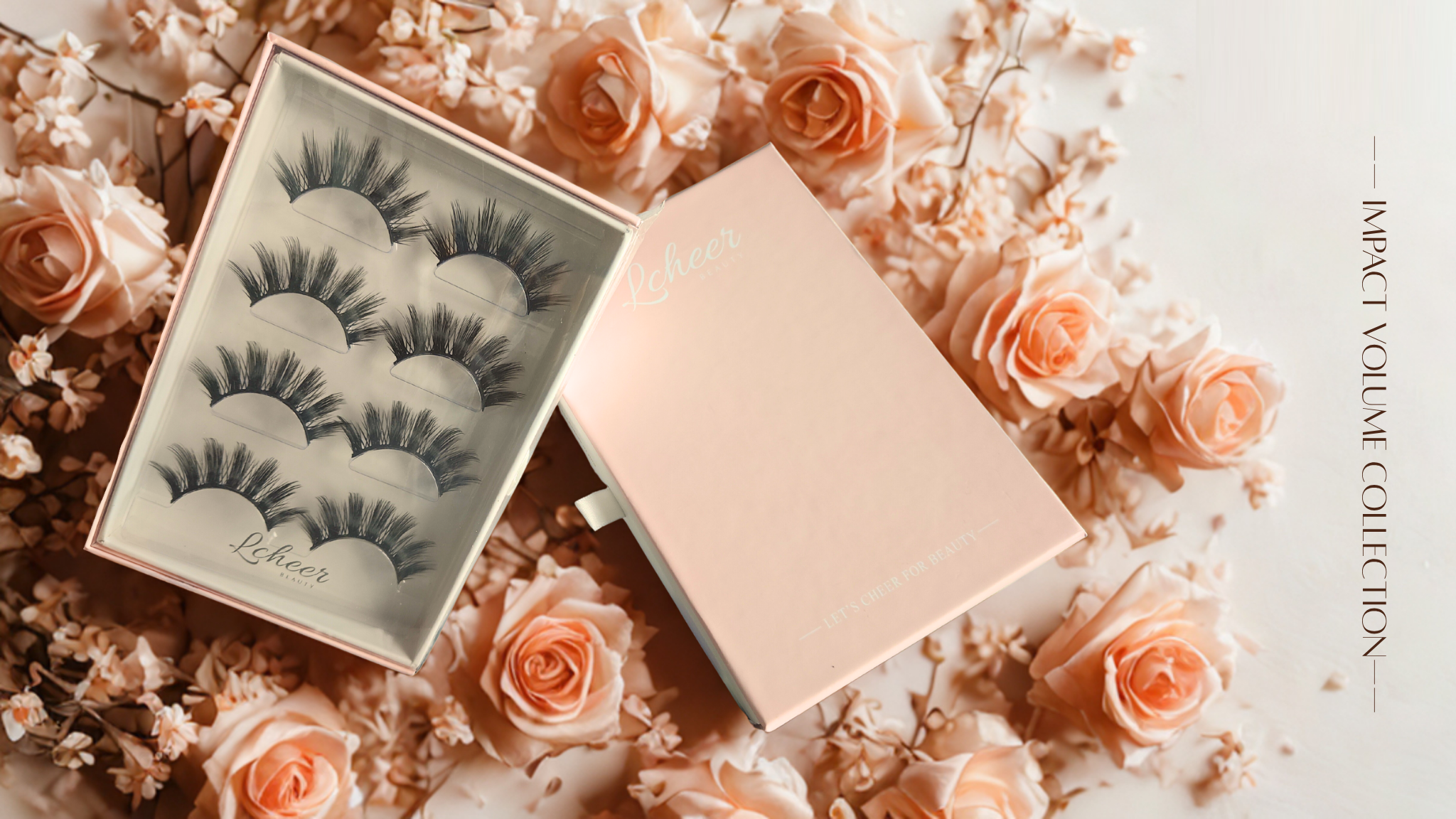 LCHEER Beauty impact-volume false lash gift set—clear display case and pink outer box on a rose and dried-floral backdrop, with side text “Impact Volume Collection”